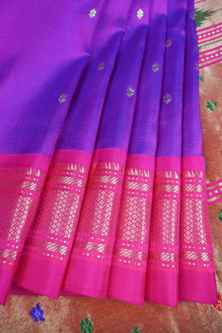 Royal purple Paithani saree with magenta zari border, gold star buttis and a geometric pallu of peacocks