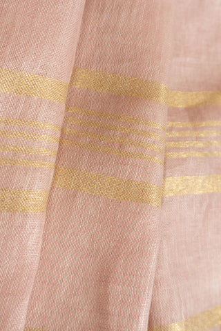 Blush pink linen saree with gold zari border and tassels