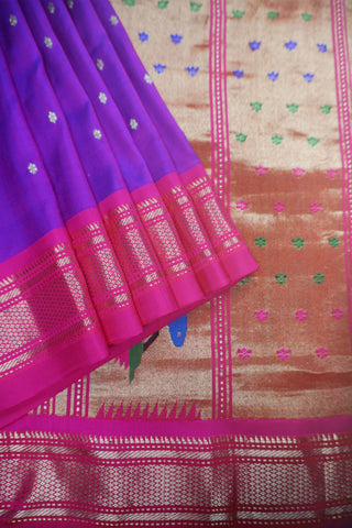 Royal purple Paithani saree with magenta zari border, gold star buttis and a geometric pallu of peacocks