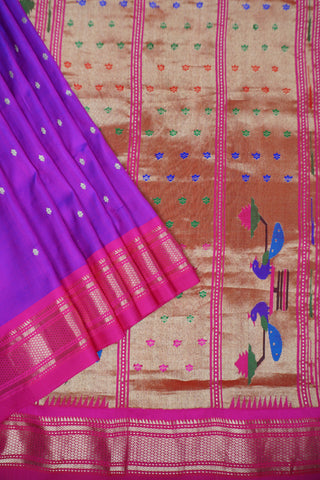 Royal purple Paithani saree with magenta zari border, gold star buttis and a geometric pallu of peacocks