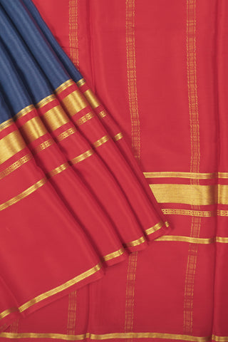 Navy blue crepe silk saree with red zari pallu