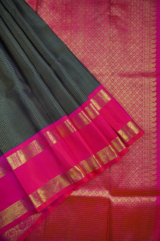 Deep bottle green Kanjivaram silk saree with gold checks and a rani pink elephant and peacock border