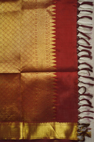 Off white Kanjivaram silk saree with gold zari paisley motifs and a deep maroon full brocade pallu