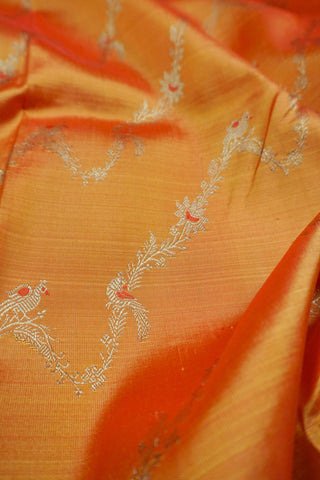 Copper orange shot silk Kanjivaram saree with red Meenakari peacock vine motifs and gold zari brocade border