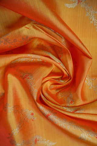 Copper orange shot silk Kanjivaram saree with red Meenakari peacock vine motifs and gold zari brocade border