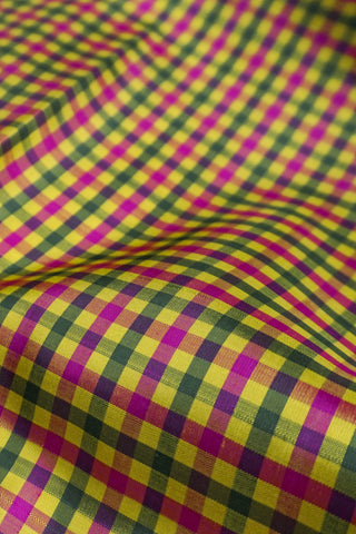 Yellow, green and rani pink micro check Kanjivaram silk cotton saree with a rani pink gold zari border