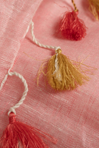 Pastel pink linen saree with red border and tassels