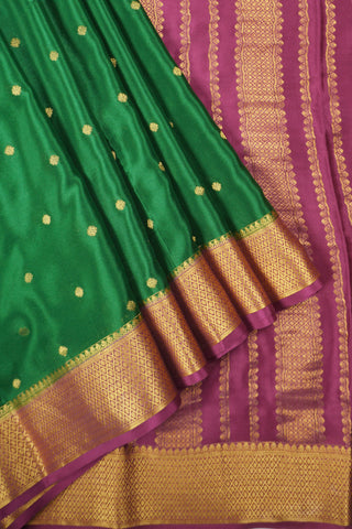 Emerald green crepe silk saree with gold zari buttas