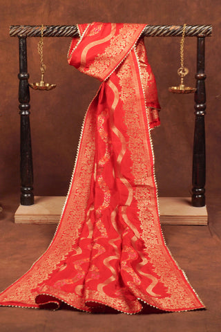 Red art silk dupatta with wavy gold zari leheriya lines, pink and orange meenakari vines and gold kiran lace edging
