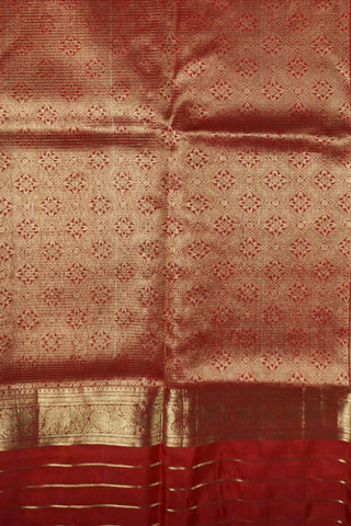 Ruby red Kanjivaram silk saree with gold micro checks, floral buttas and a bottle green selvedge border