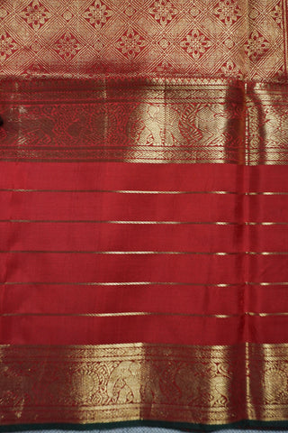 Ruby red Kanjivaram silk saree with gold micro checks, floral buttas and a bottle green selvedge border
