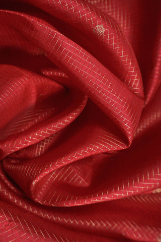Ruby red Kanjivaram silk saree with gold micro checks, floral buttas and a bottle green selvedge border