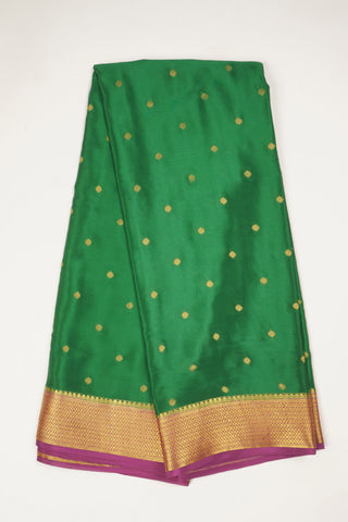 Emerald green crepe silk saree with gold zari buttas