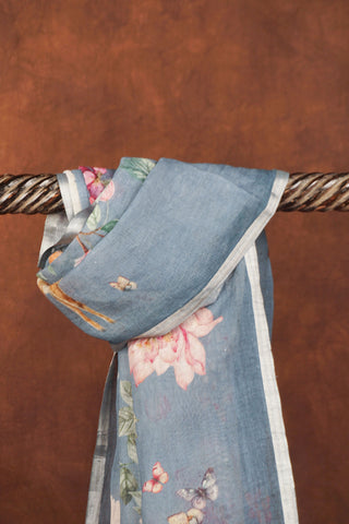Greyish blue digital printed linen saree with floral blooms, white cranes, deer and butterflies, silver zari selvedge