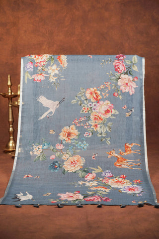 Greyish blue digital printed linen saree with floral blooms, white cranes, deer and butterflies, silver zari selvedge