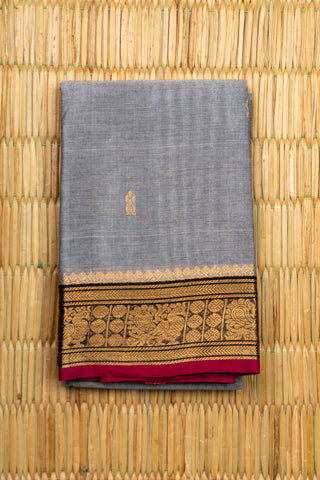 Grey Chettinad cotton saree with gold zari buttas and peacock border