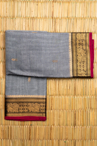 Grey Chettinad cotton saree with gold zari buttas and peacock border