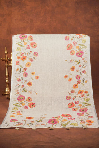 White linen dupatta with pink and peach poppy floral borders, green foliage, silver zari selvage and white tassels