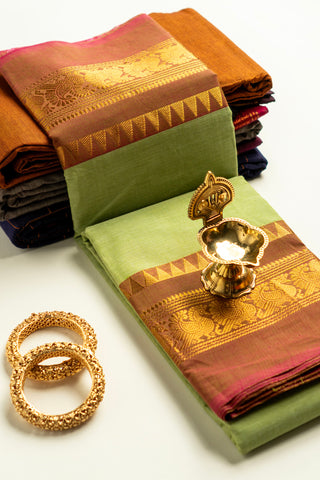 Pista green Chettinad cotton saree with rust-red and gold peacock border