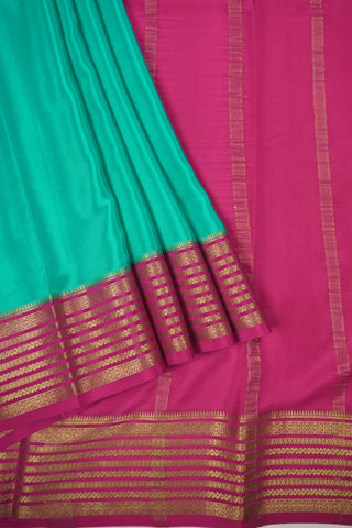 aqua blue crepe silk saree with rani pink pallu