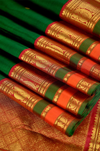 Bottle green Kanjivaram silk saree with red zari and gold motifs