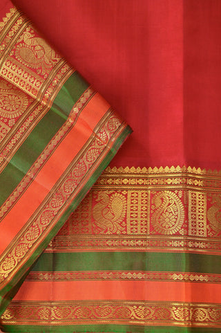 Bottle green Kanjivaram silk saree with red zari and gold motifs