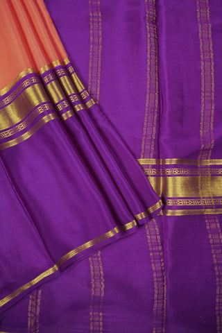 Peach orange crepe silk saree with purple zari pallu