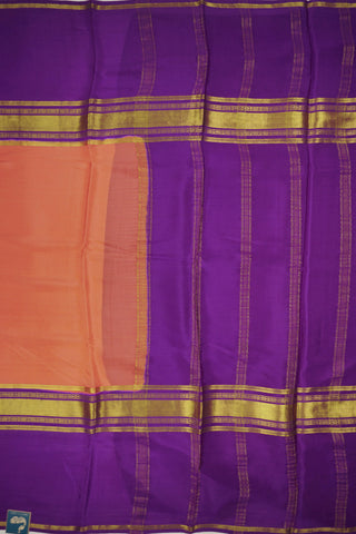 Peach orange crepe silk saree with purple zari pallu