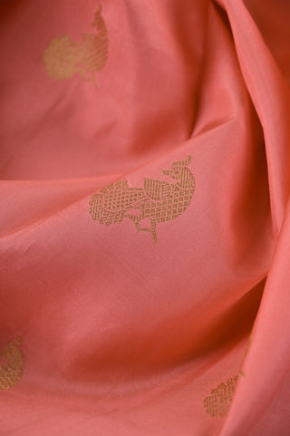 Peach Kanjivaram silk saree with blue pallu and gold motifs