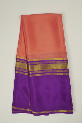 Peach orange crepe silk saree with purple zari pallu