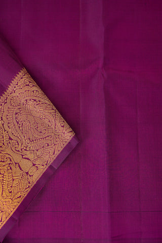 Purple Kanjivaram silk saree with gold zari and traditional peacock border