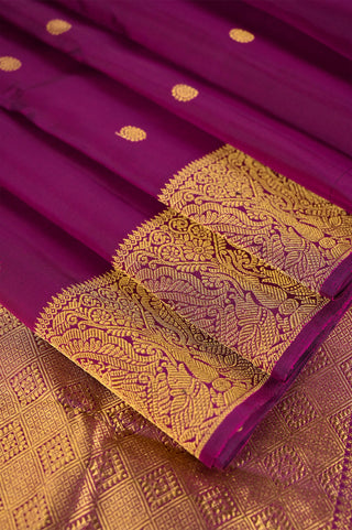 Purple Kanjivaram silk saree with gold zari and traditional peacock border