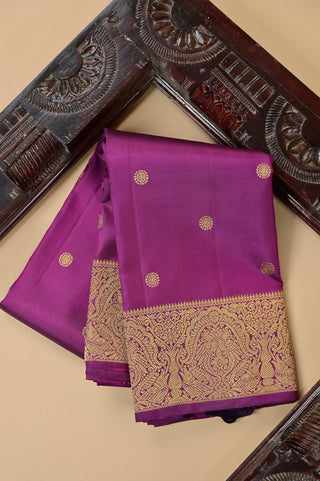 Purple Kanjivaram silk saree with gold zari and traditional peacock border