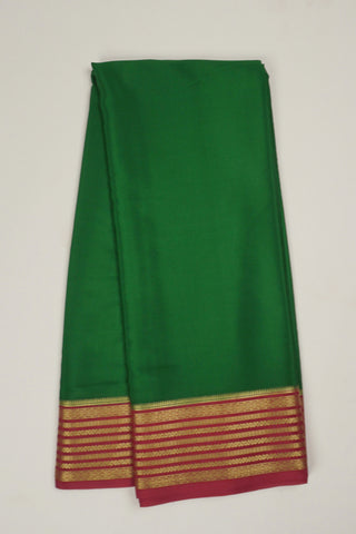 bottle green crepe silk saree with red zari pallu