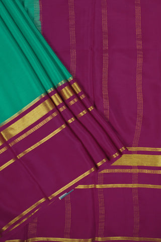 Turquoise blue crepe silk saree with pink pallu