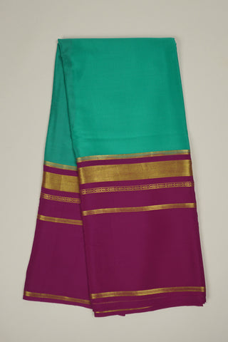 Turquoise blue crepe silk saree with pink pallu