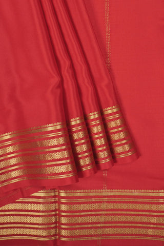 traditional red crepe silk saree with zari motifs