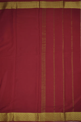 Maroon crepe silk saree with geometric zari border