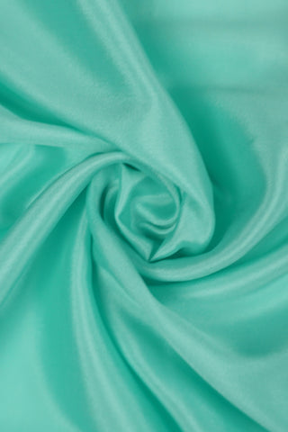 Aqua blue crepe silk saree with tassel border