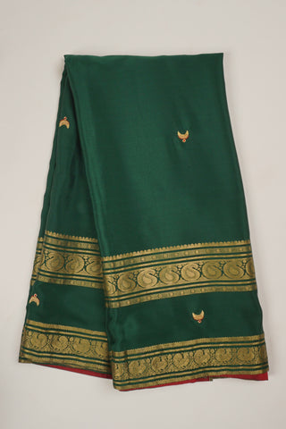 Bottle green crepe silk saree with Tanjore embroidery