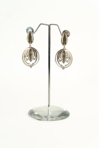 Oxidised silver-tone dangle earrings with a textured leaf top and a small leaf inside a circular hoop
