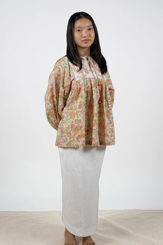 Off-White Cotton Cambric Peplum Top with Pastel Floral Block Print and Crochet Tassels