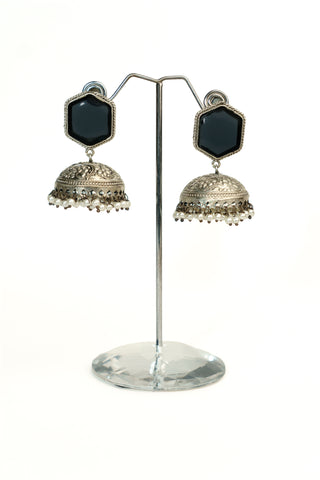 Oxidised silver replica jhumkas with a hexagonal black stone stud, floral carving and dangling pearl drops