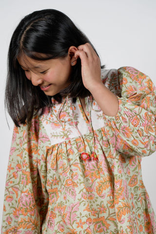 Off-White Cotton Cambric Peplum Top with Pastel Floral Block Print and Crochet Tassels