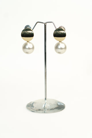 Gold finish drop earrings with a textured metallic disc top and a large white pearl hanging below