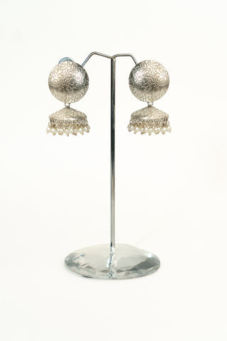 Silver replica jhumka earrings with an engraved filigree circular stud, a matching dome and pearl droplets