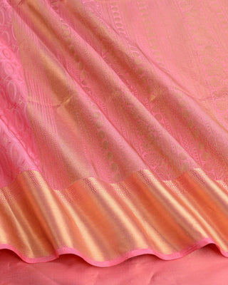 Soft pink handwoven pure silk saree with oval matrix pattern and gold zari striped pallu