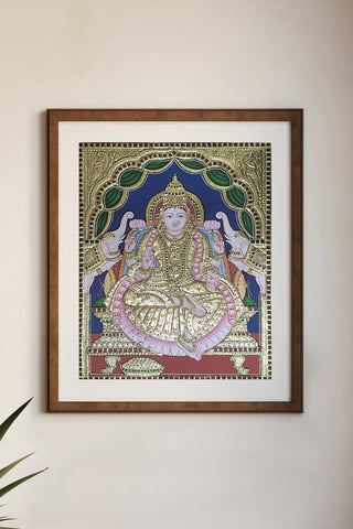 Handcrafted Gajalakshmi Tanjore painting with 22K gold leaf and semi-precious stones	