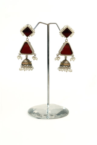 Long oxidised silver replica jhumkas with maroon square and triangular stone tiers, pearl borders and drops