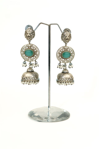 Oxidised silver replica long jhumkas with a lion-face stud, sea-green oval stone, carved dome and pearl beads